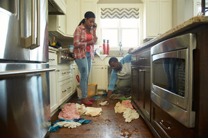 homeowner calling home insurance for help with water damage restoration services
